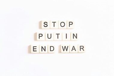 scrabble letters spelling the word stop, put in end war